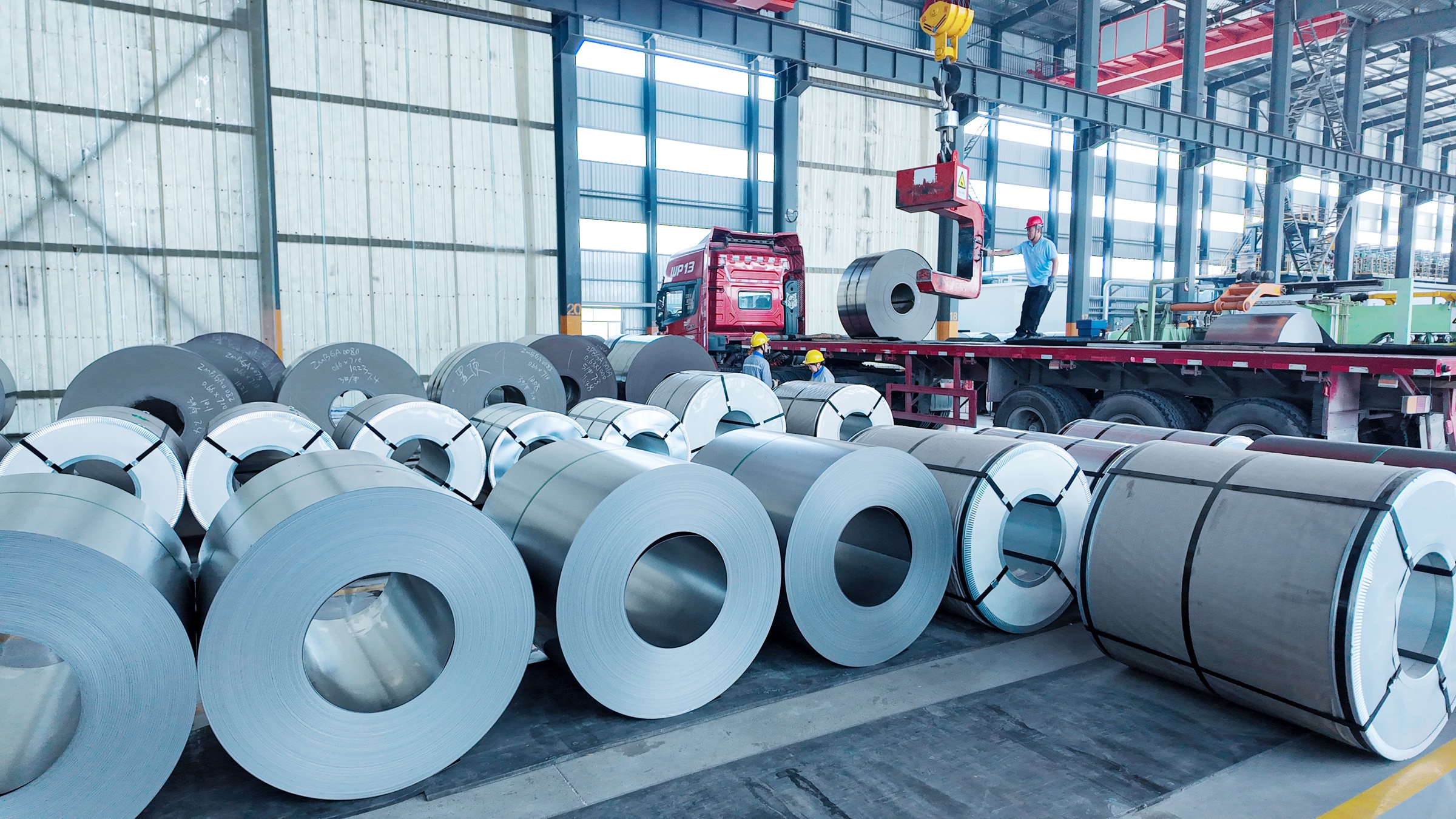 Steel coils being loaded onto a truck inside the Huiding Steel facility