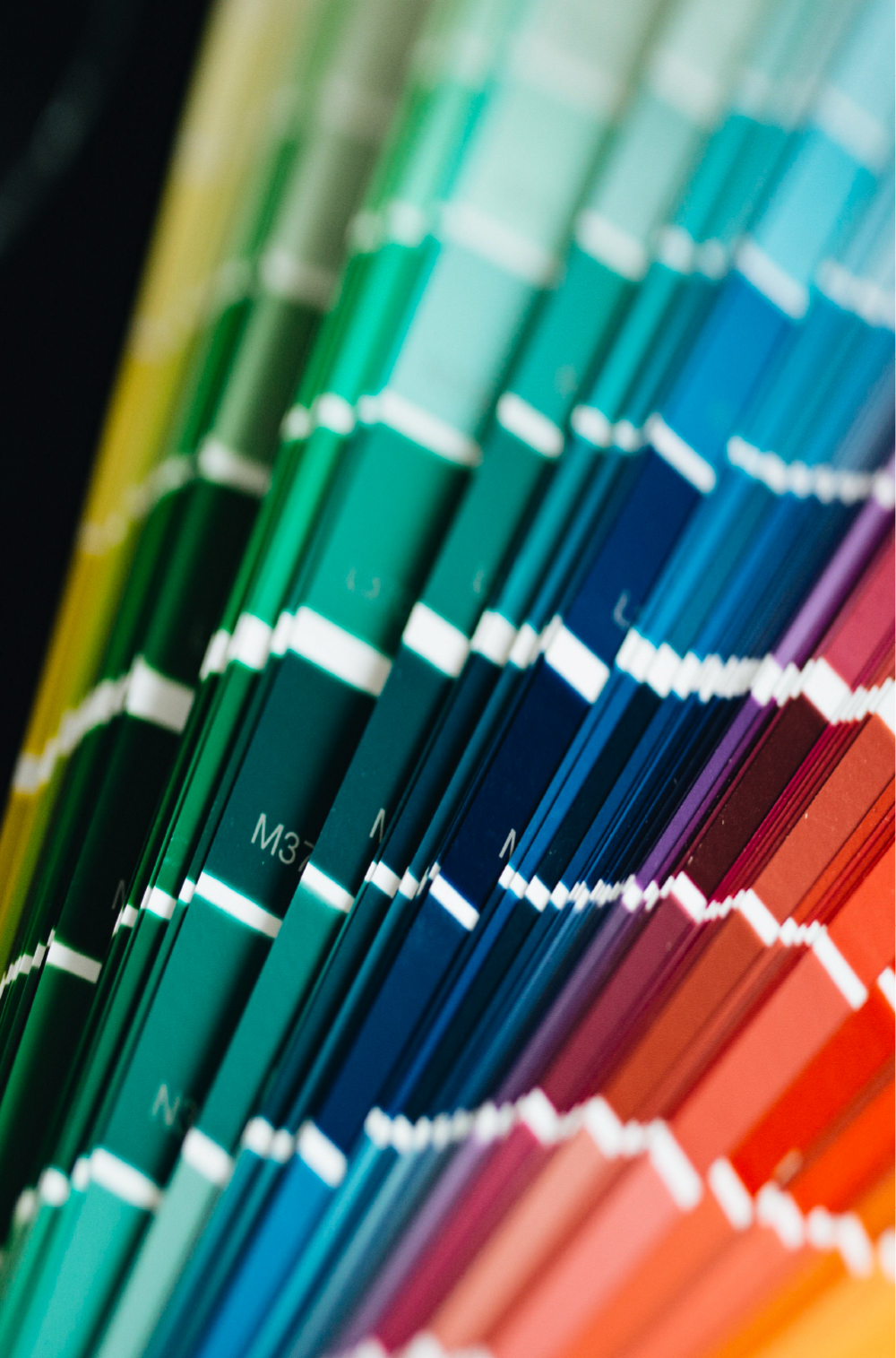 Fan of solid color samples ranging from green and blue to red and orange