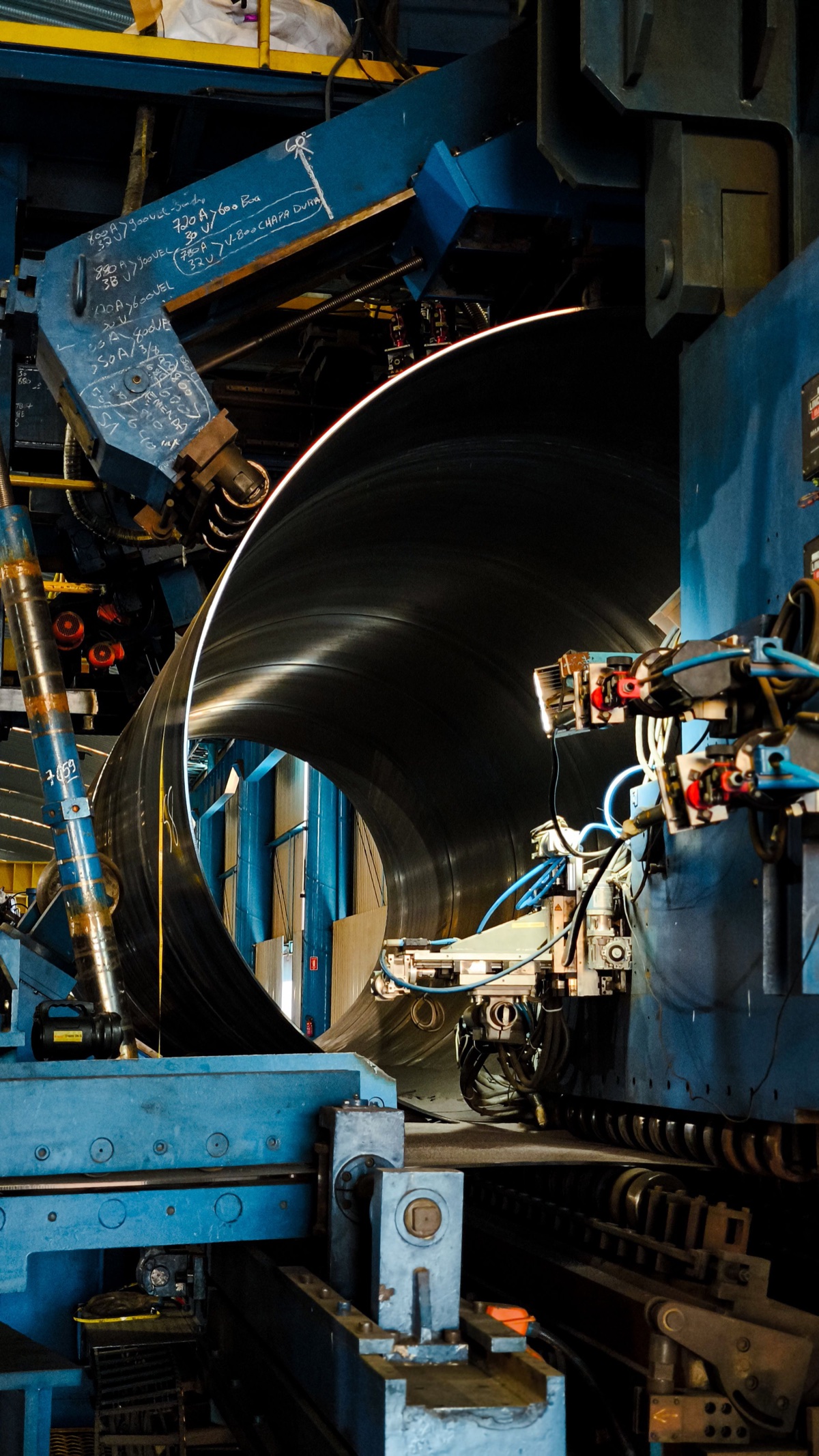 Automated equipment processing steel in a factory