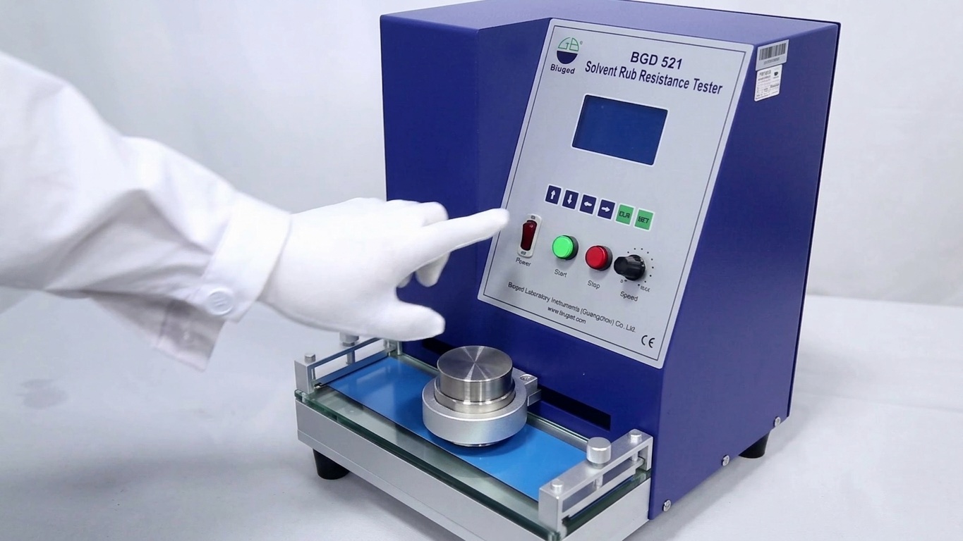 A technician operating a steel coating bend test machine