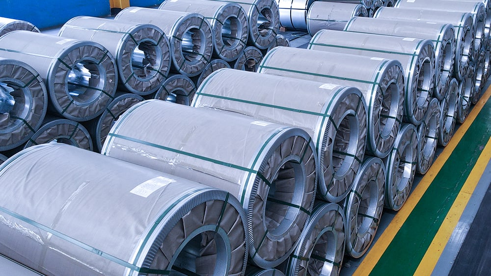 Rows of galvanized steel coils stored in the production facility